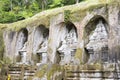 Gunung Kawi 8m high scupltures carved into the rock face resting Royalty Free Stock Photo