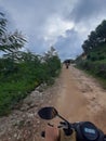 POV in over head shot from a motorbike driving on a country path.