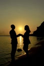 Silhouette of a loving couple enjoying the sunset on the beach