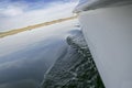 Gunwale view of sailboat sailing across Alange Reservoir, Spain Royalty Free Stock Photo