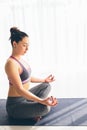 Guptasana. Beautiful yoga woman practice in a traning hall background. Royalty Free Stock Photo