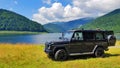 Mercedes G-class on a side of a lake landscape - Gura apelor Lake, Retezat mountains, Hunedoara, Romania