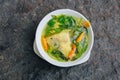 Gurame fish head soup or sup kepala ikan gurame with basil leaves, tomatoes, yellow curry, and chilli in a bowl. Indonesian food