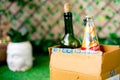 Alcohol in a cardboard box with beer and wine home delivered through online app shot in a garden at home