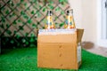 Alcohol in a cardboard box with beer and wine home delivered through online app shot in a garden at home