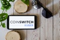 indian startup blockchain bitcoin altcoin app coinswitch kuber on a mobile phone on a wooden table showing this easy