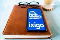 popular indian travel app ixigo on a mobile phone showing an blue cover and a train for hotel, travel and IRCTC booking