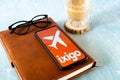 popular indian travel app ixigo on a mobile phone showing an orange cover and an aircraft for hotel, travel and IRCTC