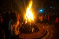 Giant bon fire lit for the festival of Lohri surrounded by people Royalty Free Stock Photo