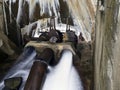 Gushing water from broken pipes in an old dam.