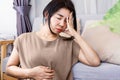 Gut-Brain Axis and anxiety concept with stress Asian woman have problems with digestion systems, stomachache, irritable bowel