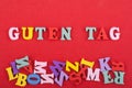 GUTEN TAG word on red background composed from colorful abc alphabet block wooden letters, copy space for ad text Royalty Free Stock Photo