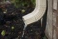 Gutter Downspout with water - side view Royalty Free Stock Photo