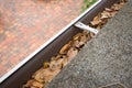 Gutter filled with leaves Royalty Free Stock Photo