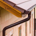 Gutter on house corner. Metal eave on roof Royalty Free Stock Photo