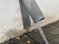 Gutter pipe line after rain with water drainage. drain pipe. Royalty Free Stock Photo