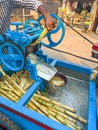 Guwahati, India - March 19, 2020: Street side sugarcane juice maker, making the juice by crashing the sugercanes. Royalty Free Stock Photo