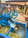 Guwahati, India - March 19, 2020: Street side sugarcane juice maker, making the juice by crashing the sugercanes. Royalty Free Stock Photo