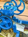 Guwahati, India - March 19, 2020: Street side sugarcane juice maker, making the juice by crashing the sugercanes. Royalty Free Stock Photo