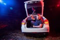 Guy with an axe in the trunk of a car in a night time Royalty Free Stock Photo