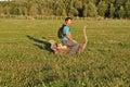 The guy with the backpack sits on ostrich