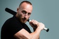 Guy with baseball bat for fighting. Dangerous man with serious emotion. Self defense.