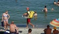 Guy on the beach serving food to vacationers