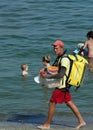 Guy on the beach serving food to vacationers