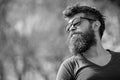 Guy with beard wears sunglasses. Hipster with beard and mustache on strict face, nature background, defocused. Man with Royalty Free Stock Photo
