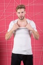 Guy bearded attractive tearing off shirt. Masculinity concept. Man with bristle strict concentrated face undressing Royalty Free Stock Photo