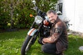 Guy biker hipster portrait handsome bearded man aside motorcycle neoretro classic bike