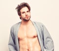 Guy in blue bathrobe with torso and six packs. Royalty Free Stock Photo