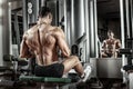 Guy bodybuilder with exercise machine Royalty Free Stock Photo