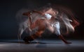 Guy breakdancer dancing hip-hop on the floor in studio on black background. Dance school poster. Long exposure shot Royalty Free Stock Photo