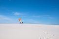 Guy in the bright shirt does a trick on the snowboard in the des Royalty Free Stock Photo