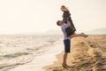 A guy carrying a girl on his back, at the beach, outdoors Royalty Free Stock Photo