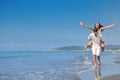 A guy carrying a girl on his back, at the beach, outdoors Royalty Free Stock Photo