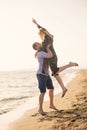 A guy carrying a girl on his back, at the beach, outdoors Royalty Free Stock Photo