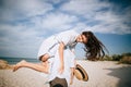 Guy carrying a girl on his back, at the beach, outdoors. Love concept Royalty Free Stock Photo