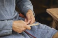 Guy carving wood at viking festival in Denmark. Close-up Royalty Free Stock Photo