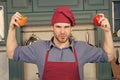 Guy in chef hat, apron hold red and orange peppers Royalty Free Stock Photo