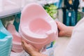 A guy chooses a potty for a baby in a store Royalty Free Stock Photo