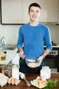 Guy cooking omelet with flour Royalty Free Stock Photo