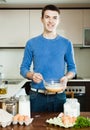 Guy cooking omelet with flour Royalty Free Stock Photo