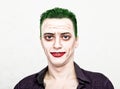 Guy with crazy joker face, green hair and idiotic smike. carnaval costume Royalty Free Stock Photo