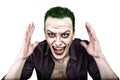 Guy with crazy joker face, green hair and idiotic smike. carnaval costume