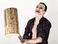 Guy with crazy joker face, green hair and idiotic smile. carnaval costume. holding hammer for cricket Royalty Free Stock Photo