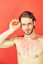 Guy with creative fashionable makeup hold grapefruit, vitamin