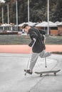 Guy on crutches jumping off skateboard Royalty Free Stock Photo