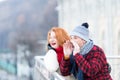Guy crying on bridge. Man with horn and happy woman. Happy pair calling to friends. Urban couple have fun in city on bridge Royalty Free Stock Photo